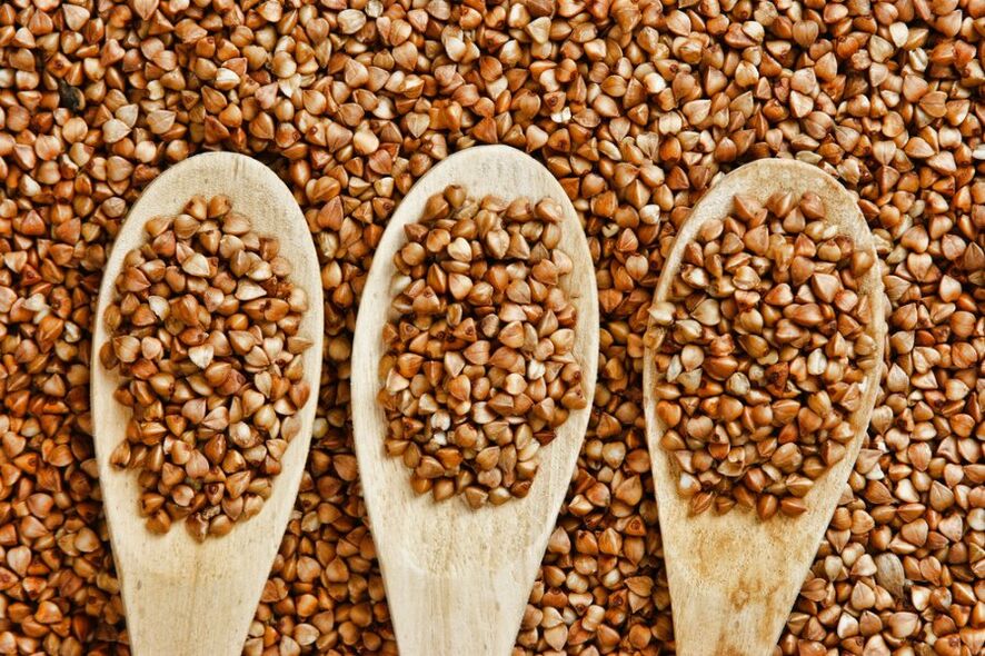 Buckwheat in wooden spoons